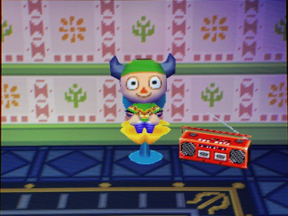 Doubutsu no Mori (N64) - Animal Crossing character in a Bear shirt sitting on a yellow tulip chair and listening to music playing from a red tape deck