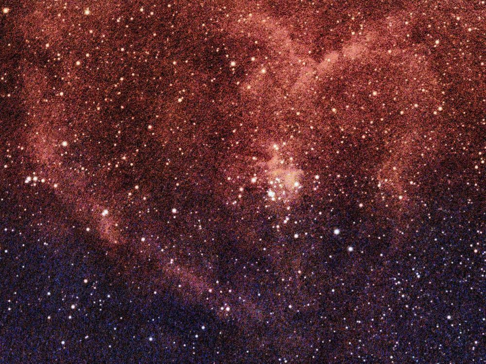 The Heart Nebula, cataloged as IC 1805 and also known as the Running Dog Nebula, is a large, heart-shaped emission nebula and active star-forming region. Located 7,500 light-years away in the constellation Cassiopeia, its characteristic red glow is caused by a small cluster of hot, young stars at its core.
