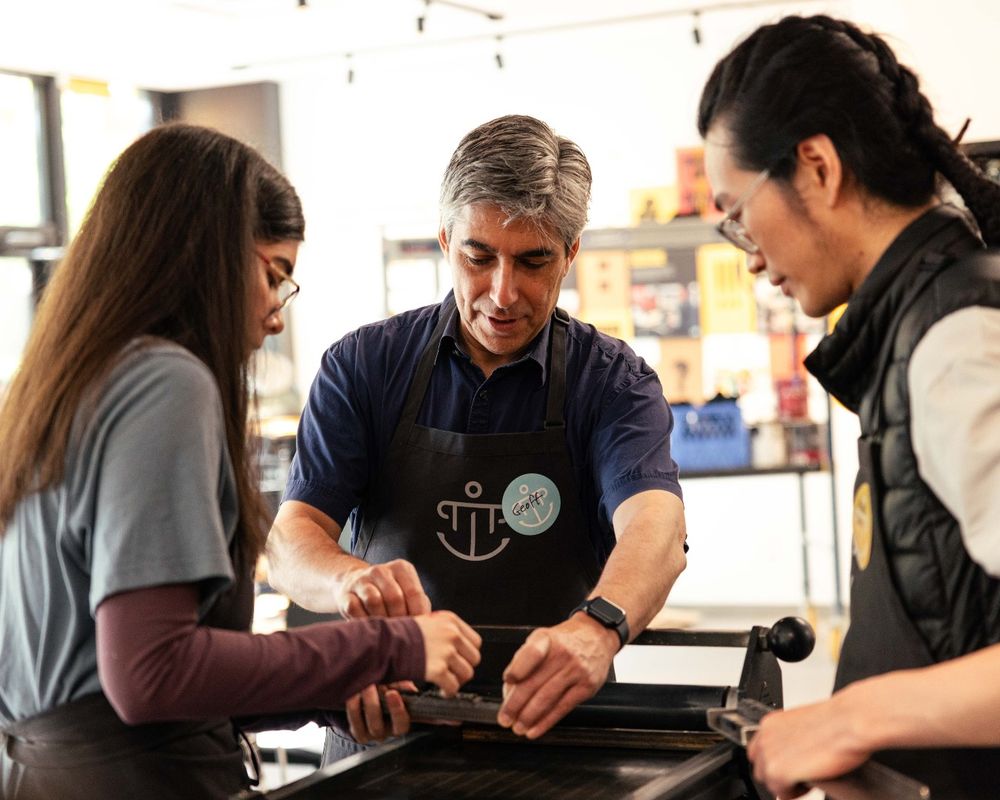 Students from the University of Washington Textual Studies 402: Book Arts course working on letterpress printing with Professor Geoffrey Turnovsky at Partners in Print.