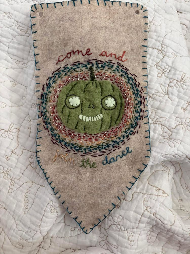 A little banner with a cute little green pumpkin friend