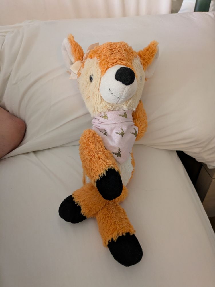 Deer plush laying in a casual pose 