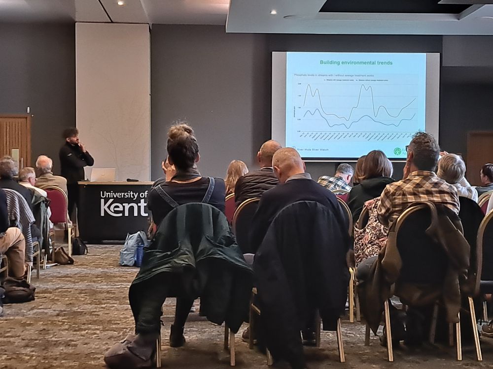 Josh Hammond speaking on river monitoring by citizen scientists. The slide shows a graph and is headed 'Building Environmental Trends'