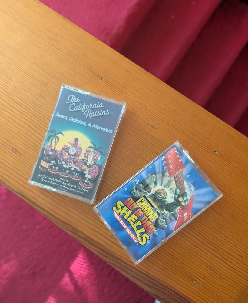 Cassette tapes: "The California Raisins: Sweet Delicious and Marvelous" and "TMNT: Coming Out of Their Shells."