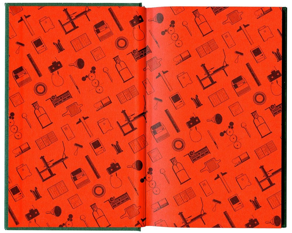 Decorated endpapers of book showing type and printing artifacts in black at an angle printed on top of a sharp red paper.