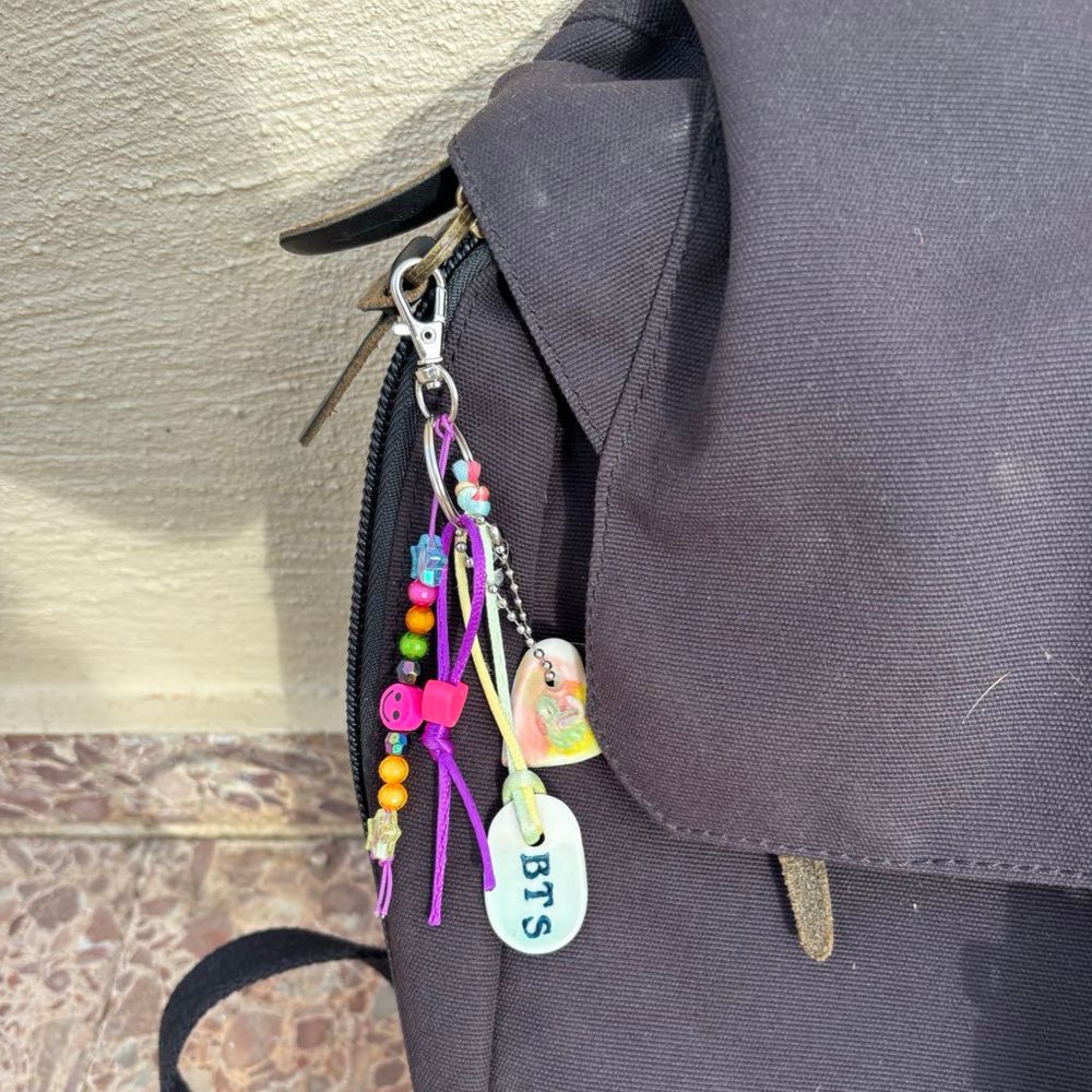 Bag charm attached to black backpack