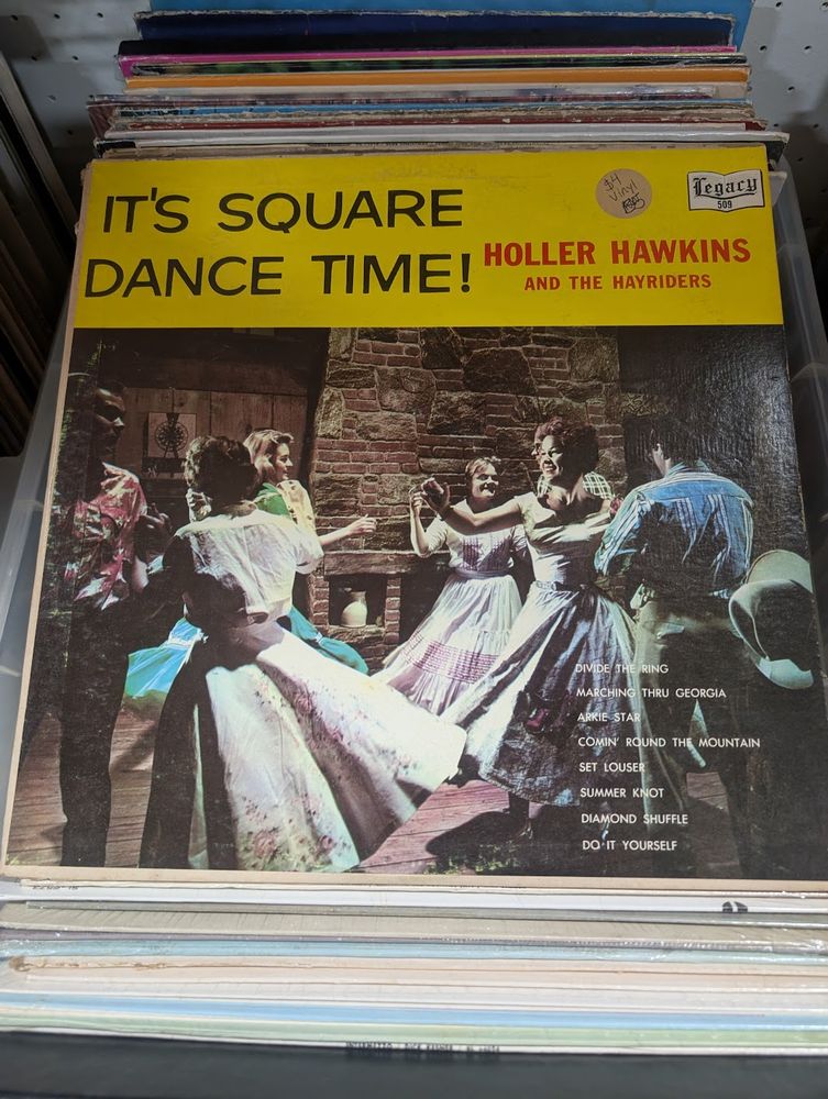 A very old vinyl record called "It's square dance time!" by "Holler Hawkins and the Hayriders"