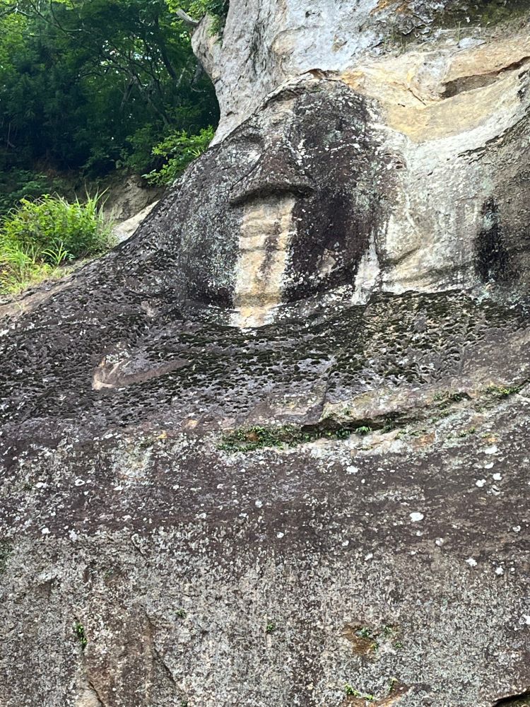 Face carved into a rock wall at Takkoku no Iwaya in Hiraizumi, Iwate. Legend was that the temple was created in 801 to celebrate the conquest of local emishi people by troops from the Imperial court in Kyoto. I have heard from local friends that tradition holds that the face of the buddha was carved out by archers' arrows.