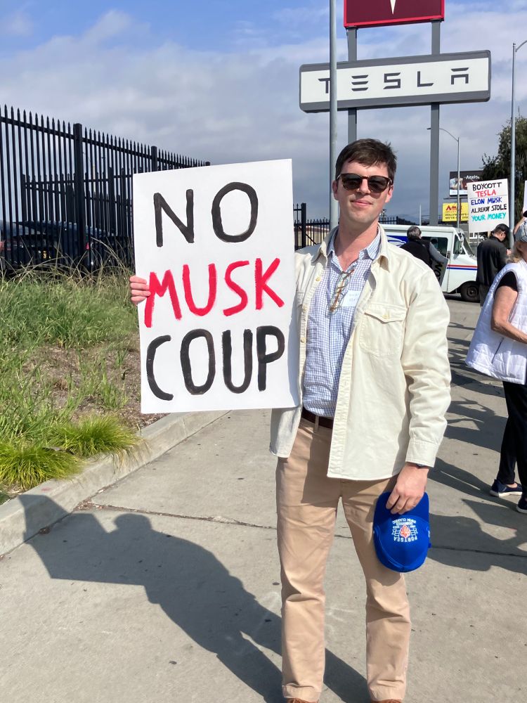 Author with a NO MUSK COUP sign in North Hollywood 