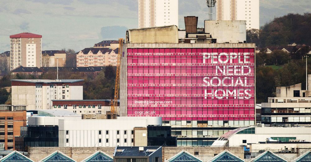 The iconic "people make Glasgow" building, instead saying "People need social homes"