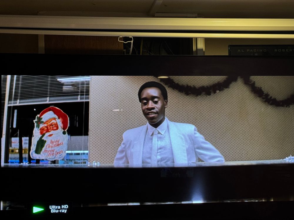 Christmas decorations behind Buck Swope in the donut shop scene