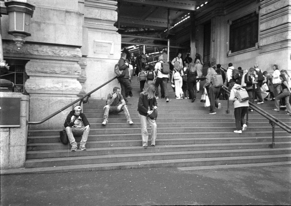 steps at waterloo station. lots of people going up and down right, left some people sitting on them