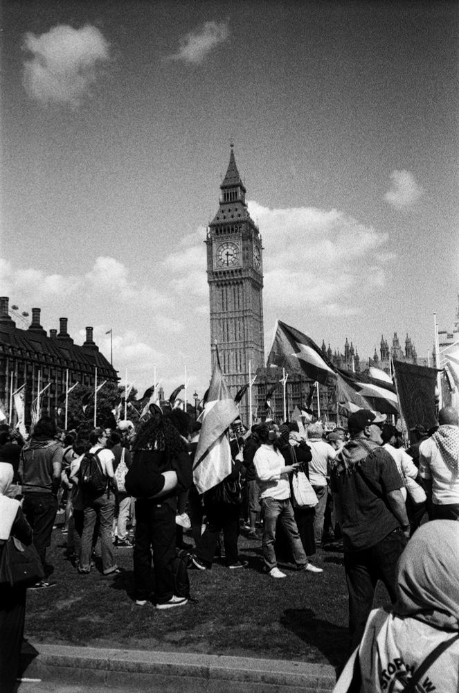 black and white photo of protesters in parliament square. clock tower behind. a few fluffy clouds in sky