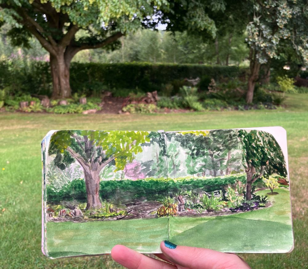 same painting held in front of actual view