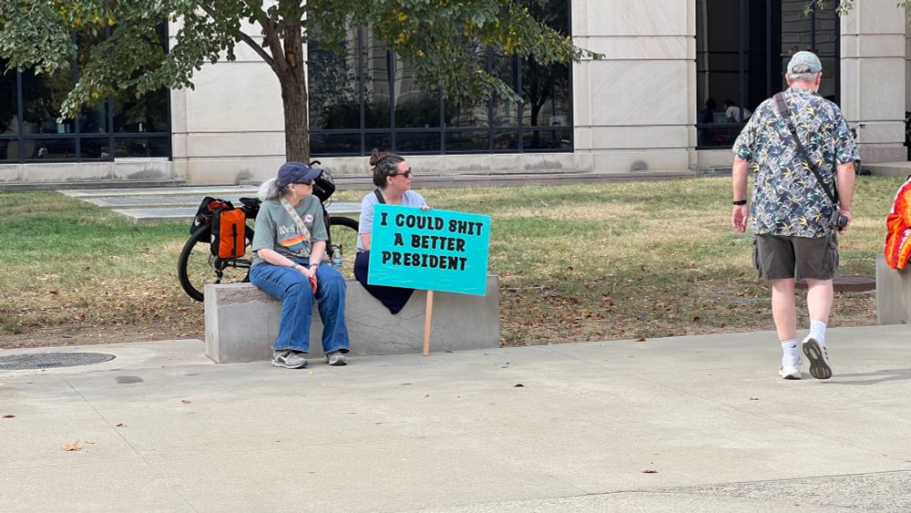 Indianapolis protesters with sign that says, “I could shit a better president.”