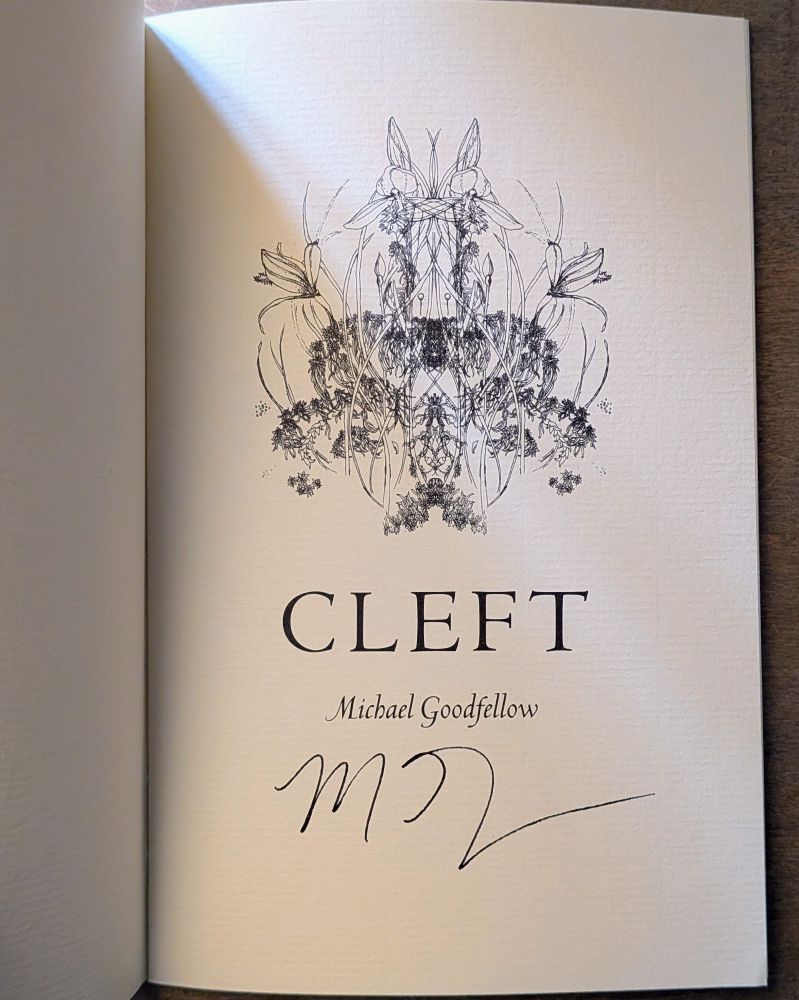 The title page of a chapbook. A mirrored image of a snakemouth orchid is printed in dark ink on the top of a beige sheet of paper. The title, Cleft, is printed, also in dark ink, in block letters underneath, and under that the author's name, Michael Goodfellow, in italics. The author has initialled the bottom.