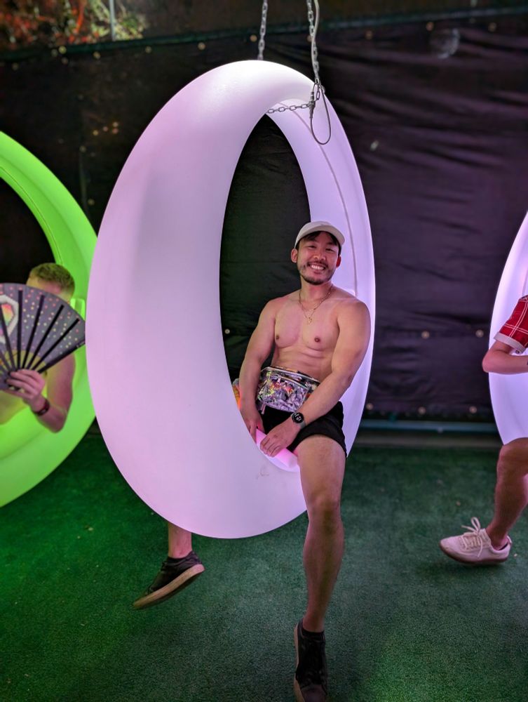 Shirtless man on a swing