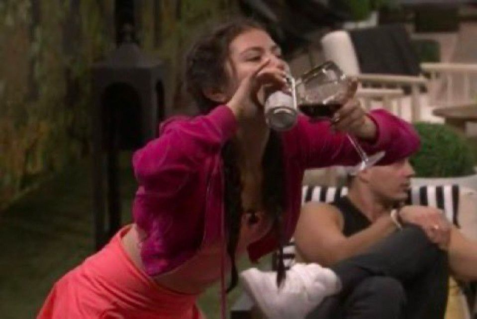 America from BB25 drinking from both a can and a glass of wine in each hand 
