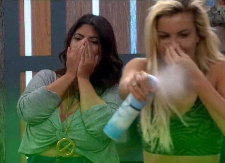 Kat Dunn and Jessica Milagros cover their noses while Kat sprays decrease at a green stink cloud 