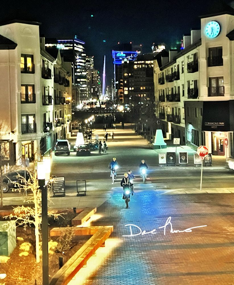 Bicyclists riding at night in near the Platte River in Denver. 