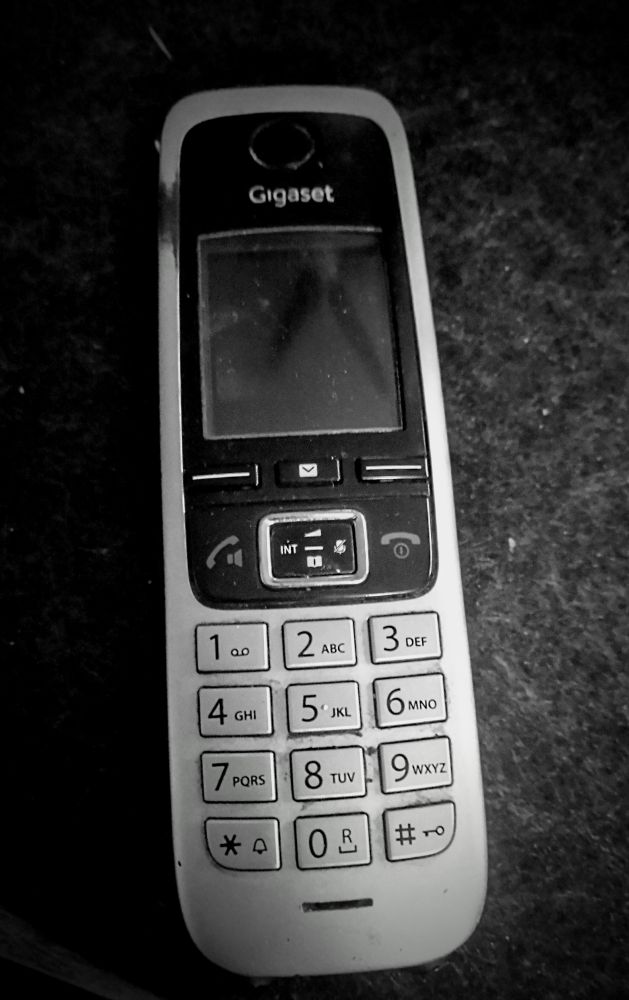 Festnetz Telefon Handteil rechteckig Grau Display schwarz Tastatur Grau Zahlen von 1 bis Null mit kleinen Buchstaben des Alphabets 