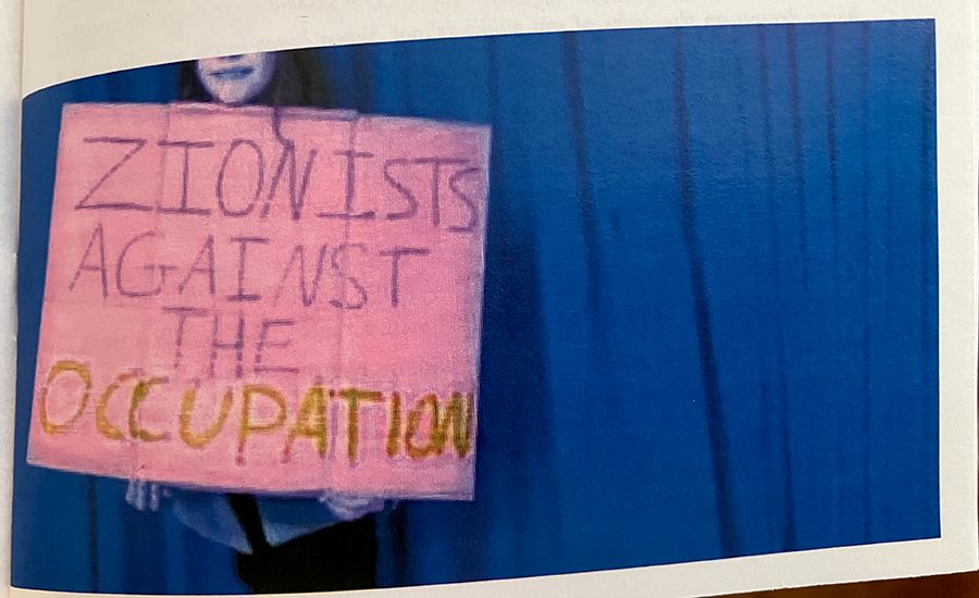 excerpt from a zine that shows someone holding a pink sign that reads 