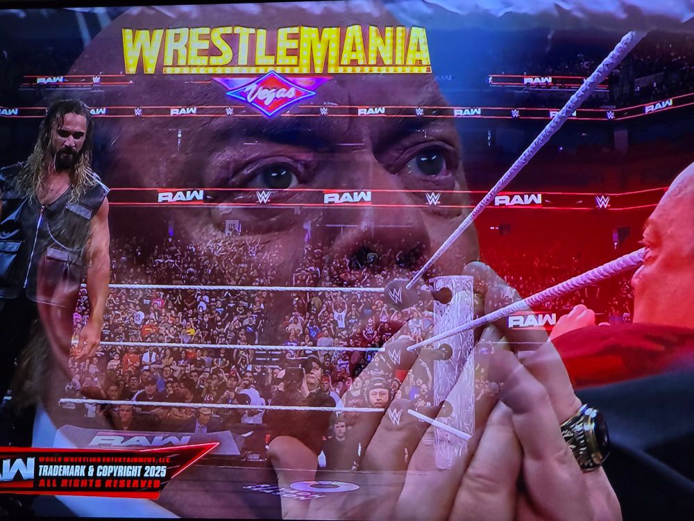 A picture of Paul Heyman looking scared overlaid a photos of Seth Rollins walking menacingly toward Paul Heyman