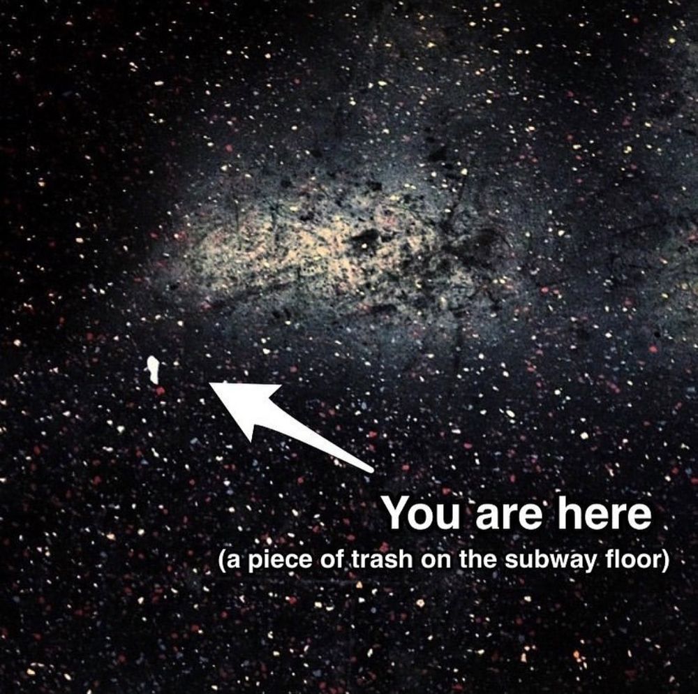 "you are here (a piece of trasch on the subway floor" 

The floor looking like stars/galaxies