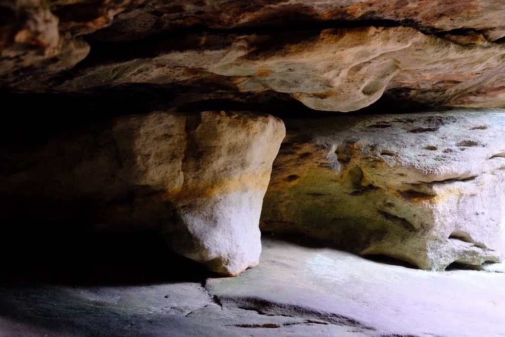 An abstract looking image of rock formations. The rocks are separated by crevasses