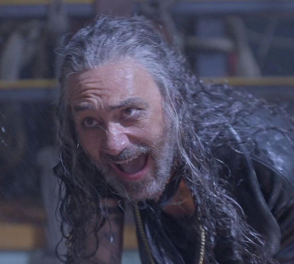 A close up frame from ofmd season 2 episode 2 of ed laughing maniacally in the storm