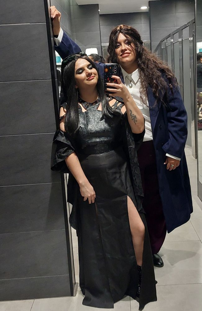 A mirror selfie of ally dressed as rio vidal and their friend dressed as agatha harkness from agatha all along