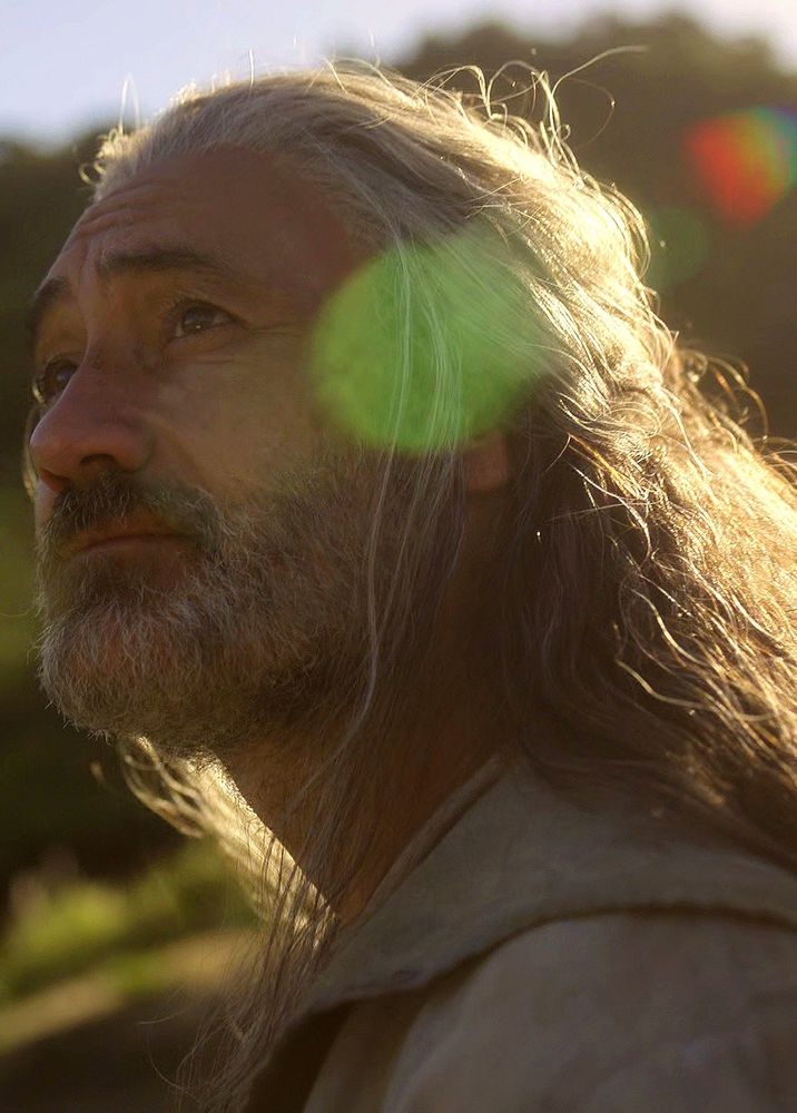 A close up screen cap from ofmd season 2 episode 8 of ed on his fisherman era looking wistful 