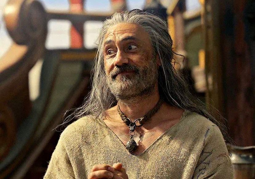 A screenshot from ofmd season 2 of ed wearing the sack clothes and cat collar