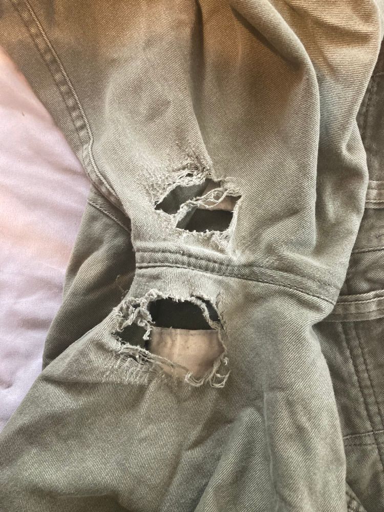 Green shorts with holes. 