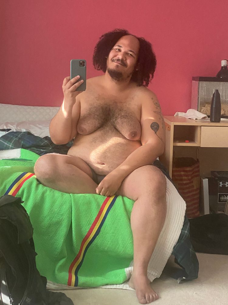 Me sitting on the ridge of the bed mosty naked taking a selfie in the mirror 