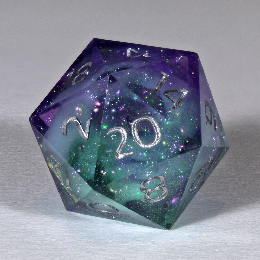 A single 20 sided die. It is a range of purple and greens. The numbers are silver