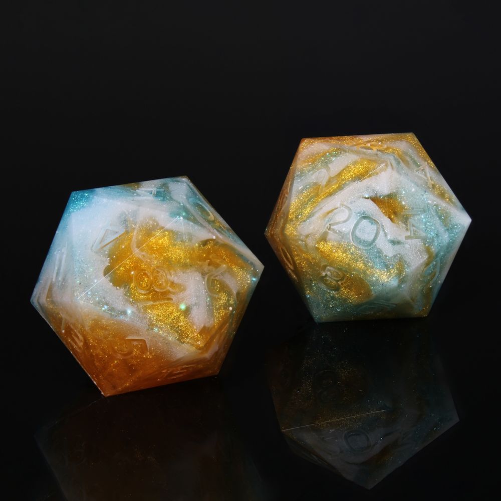 A pair of 20 sided dice. The numbers are uninked. The dice are a swirling, cloudlike blend of white, blue and orange with a subtle micro glitter shine to these colours.
