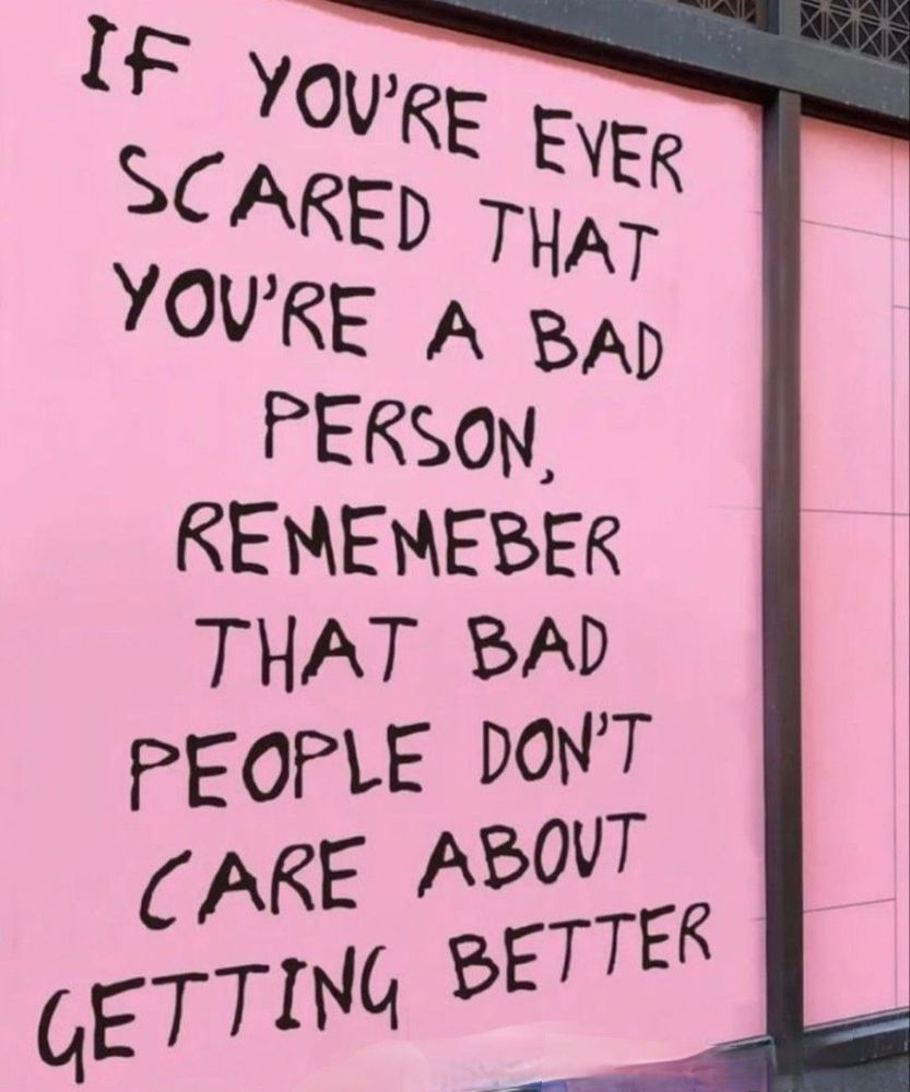 a picture of a side of a building. it is pink and has writing that reads “ If you’re scared that you’re a bad person, remember that bad people don’t care about getting better”