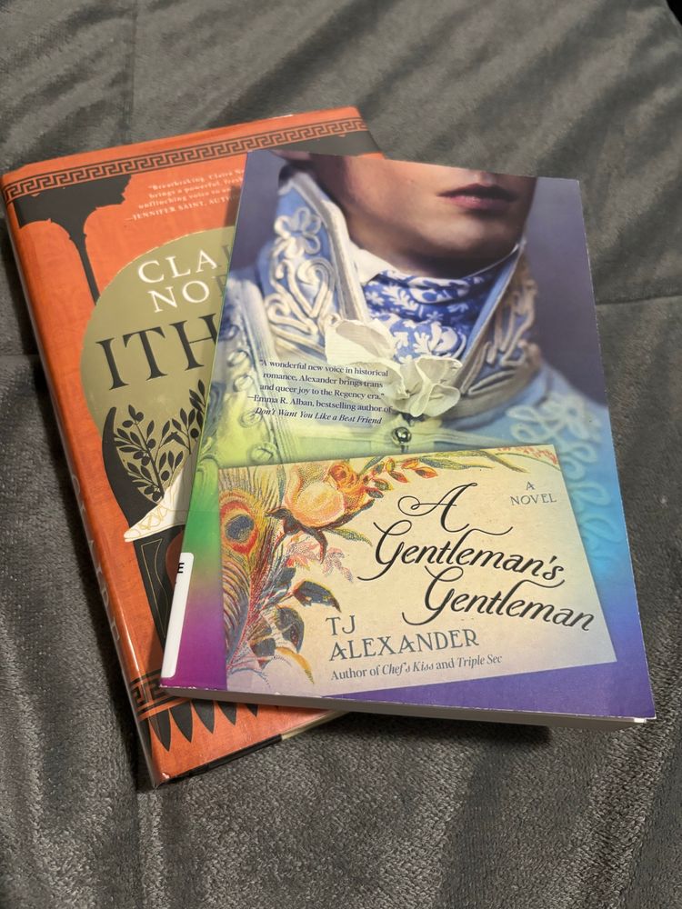 A photo of A Gentleman’s Gentleman by TJ Alexander. It lies on top of Ithaca by Claire North, which is half obscured by the first book