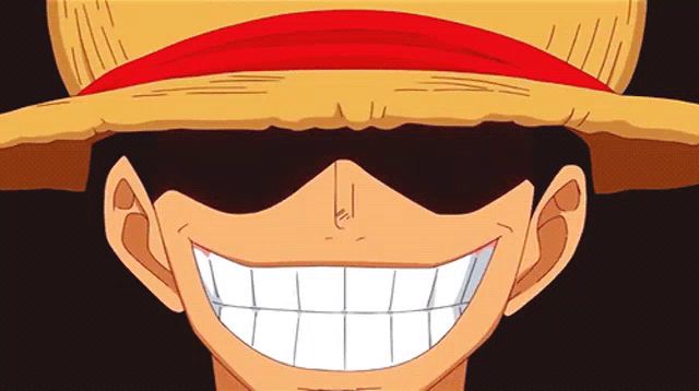 a man wearing a straw hat and sunglasses smiles