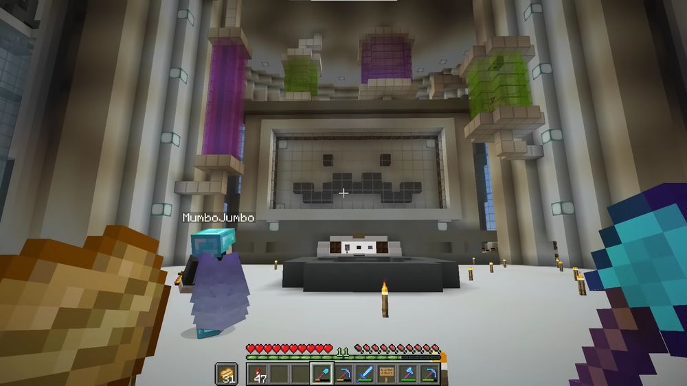 A screenshot from one of Grian's season 6 episodes, in which Mumbo is stood in front of Grian's Moustache Removal Machine. The machine has a large screen depicting a face with a moustache. 