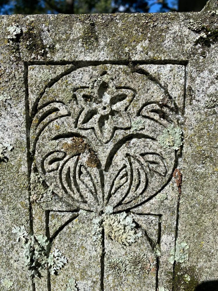 Stylized flower carving on gravestone 