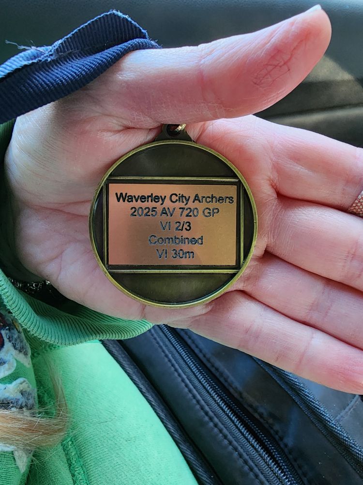 The back of the 1st place medal. Text "Waverley City Archers 2025 AV 720 GP VI 2/3 Combined VI 30m"
