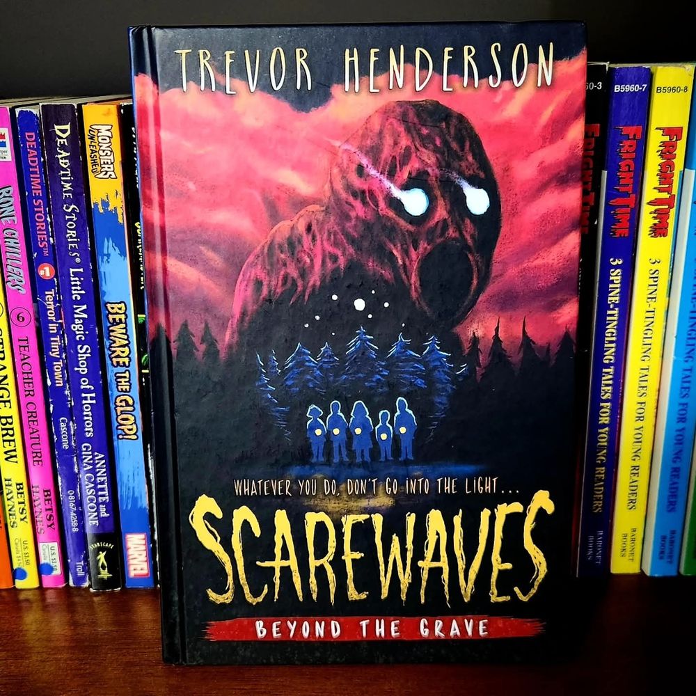 A copy of SCAREWAVES: BEYOND THE GRAVE by Trevor Henderson sitting on my shelf of mid-grade horror books.