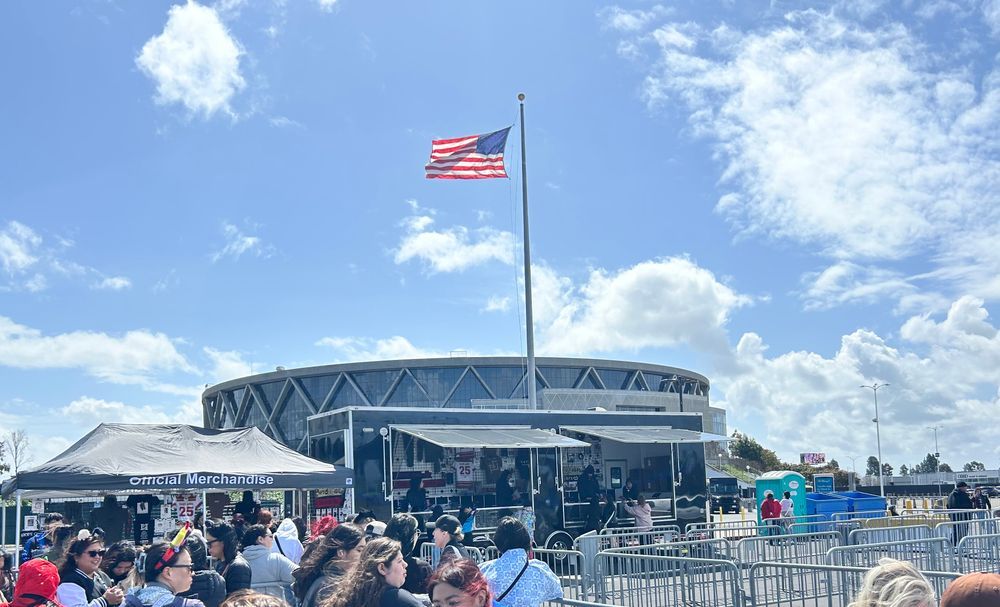 Oakland Arena from the parking lot with a view of the Hope on the Stage merch booth. 