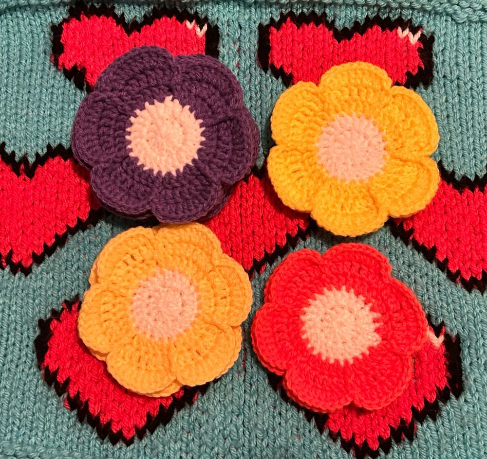 Different color crocheted flower coasters 