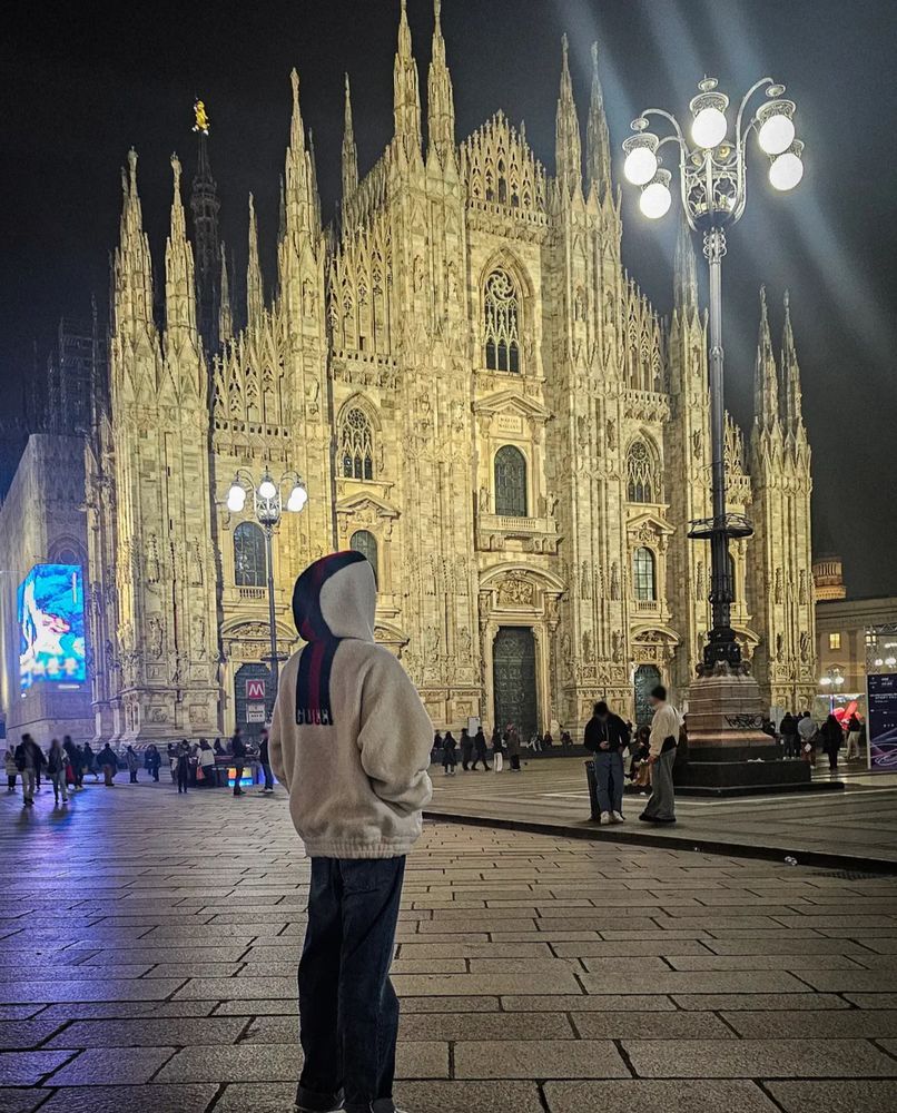 BTS Jin in front of the Duomo Milano at night