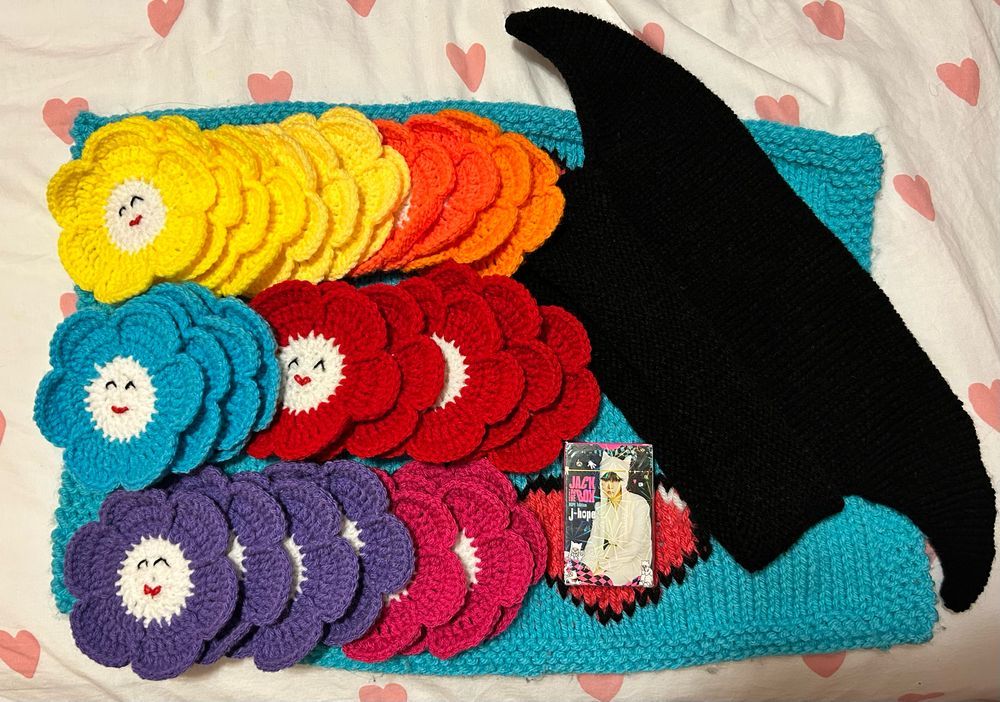 An assortment of colored flower coasters, a box of photo cards & the knit jester hat. 