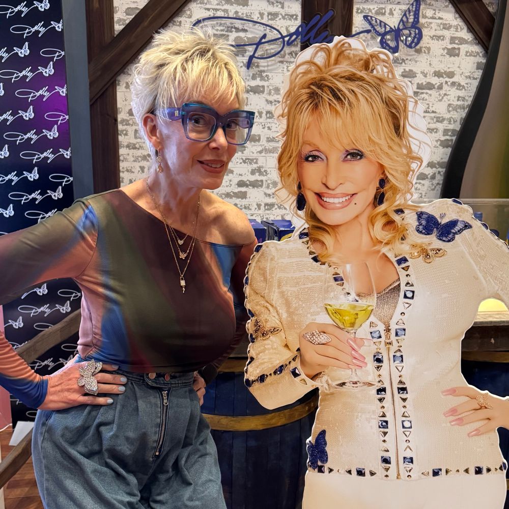 Jaime posing with a cardboard standup of Dolly Parton
