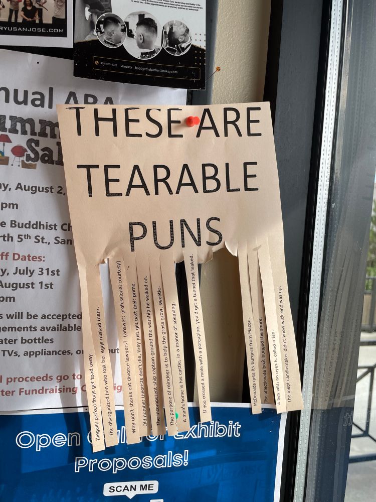 Community flyer board with a flyer that says: “These are tearable puns”. Several of the puns danglies at the bottom have been torn off. 