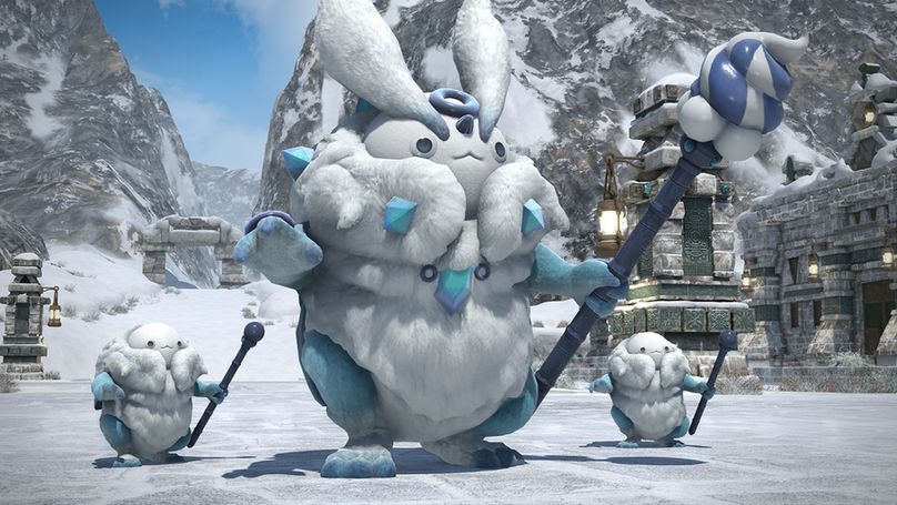 A Final Fantasy 14 screenshot of three fluffy creatures with white fur and blue arms and legs, holding scepters in their left hands, standing in a snow-covered area. The middle creature is larger than the other two, and it has long, fluffy leporine white ears.